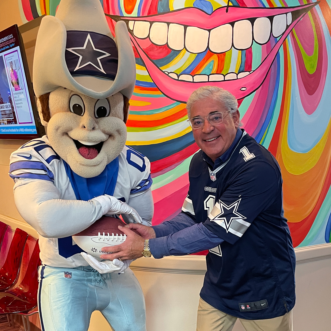 Dr Greg Greenberg, RxSmile Frisco Orthodontist poses with Rowdy, Dallas Cowboys mascot